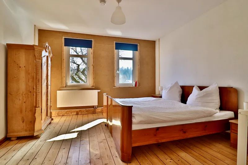 Schlafzimmer mit Doppelbett und Gitterbett